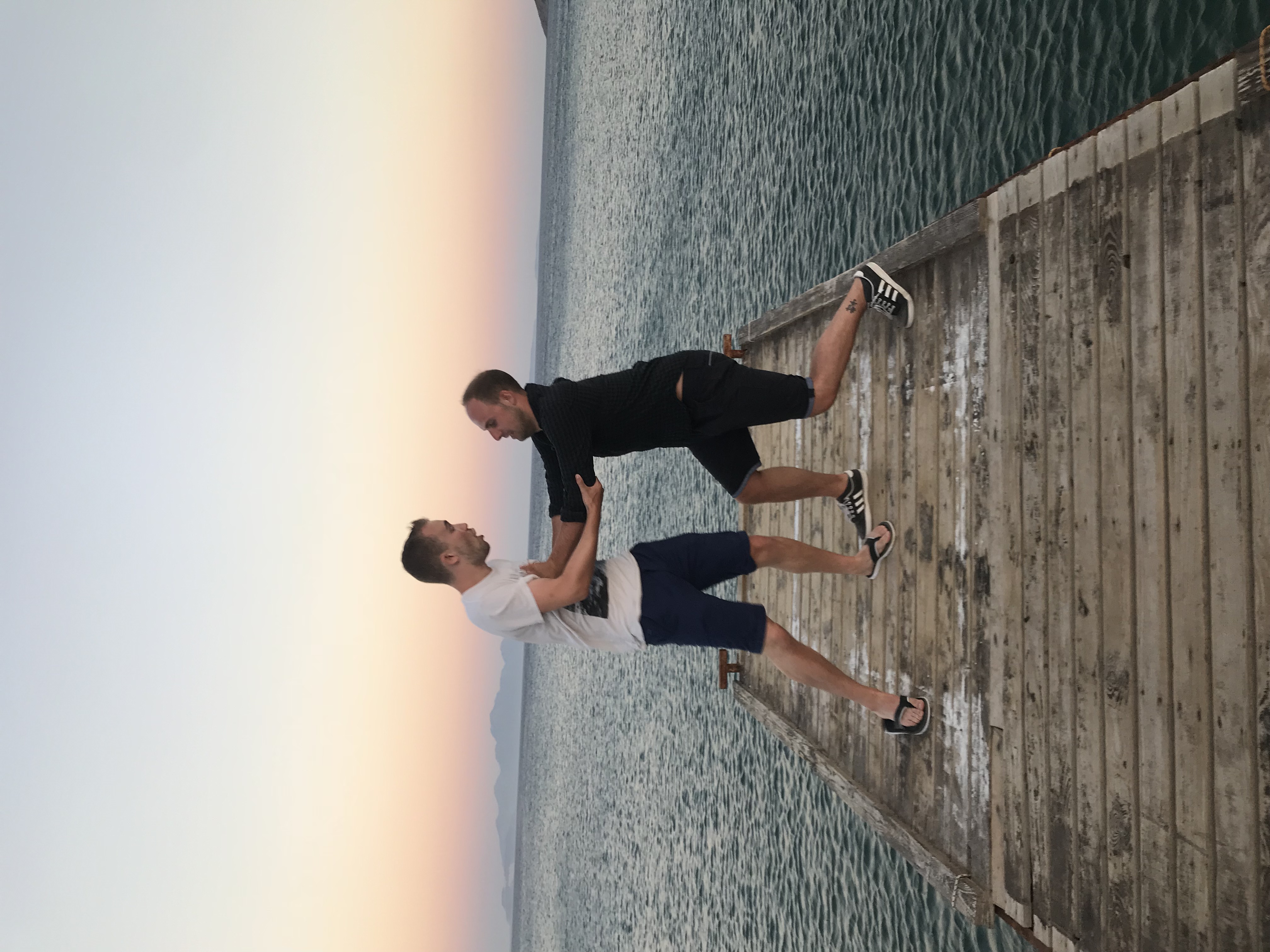 Stuart and Ewan together on a pier at sunset